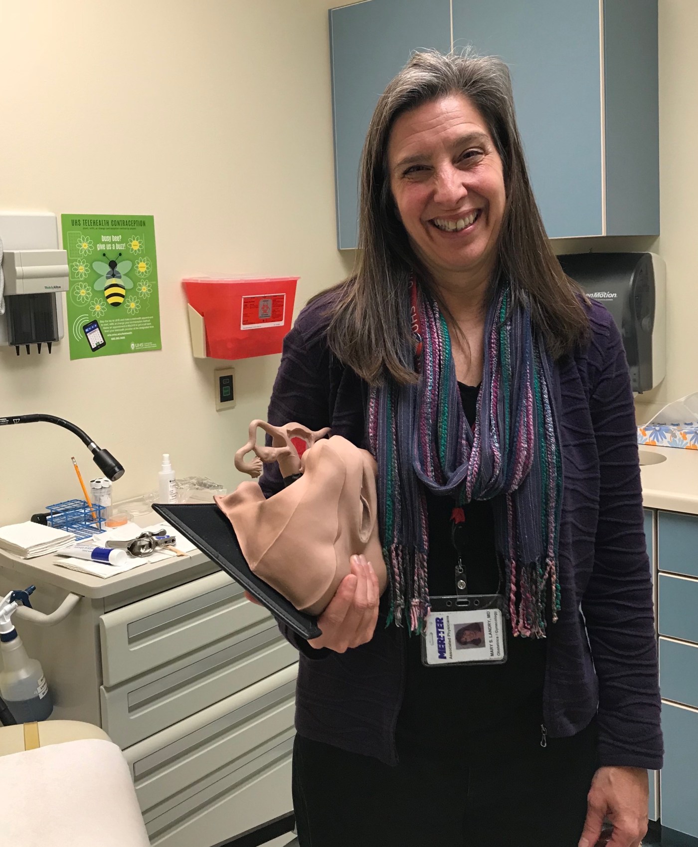 Photo by Juliet Dupont. Dr. Mary Landry at the University Health Services Women's Health Clinic holding a pelvic model used in IUD insertion training sessions.